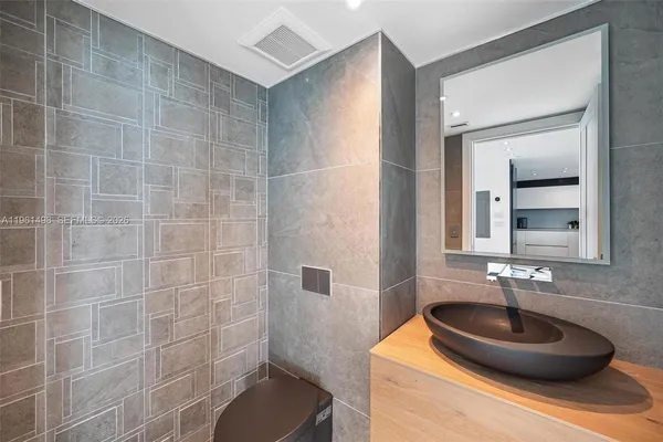 a bathroom with a sink a toilet and a mirror