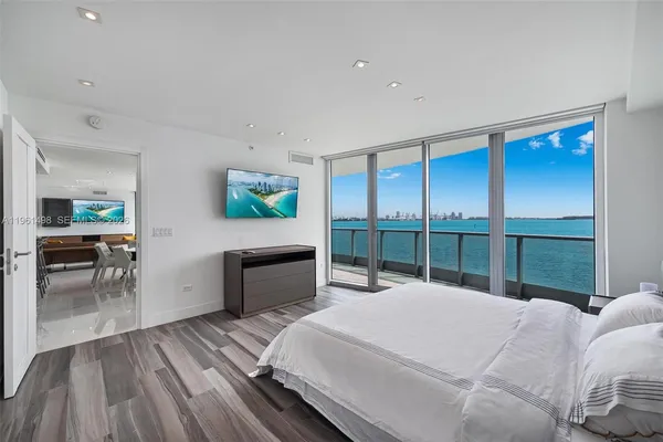 a bed room with a bed and a large window