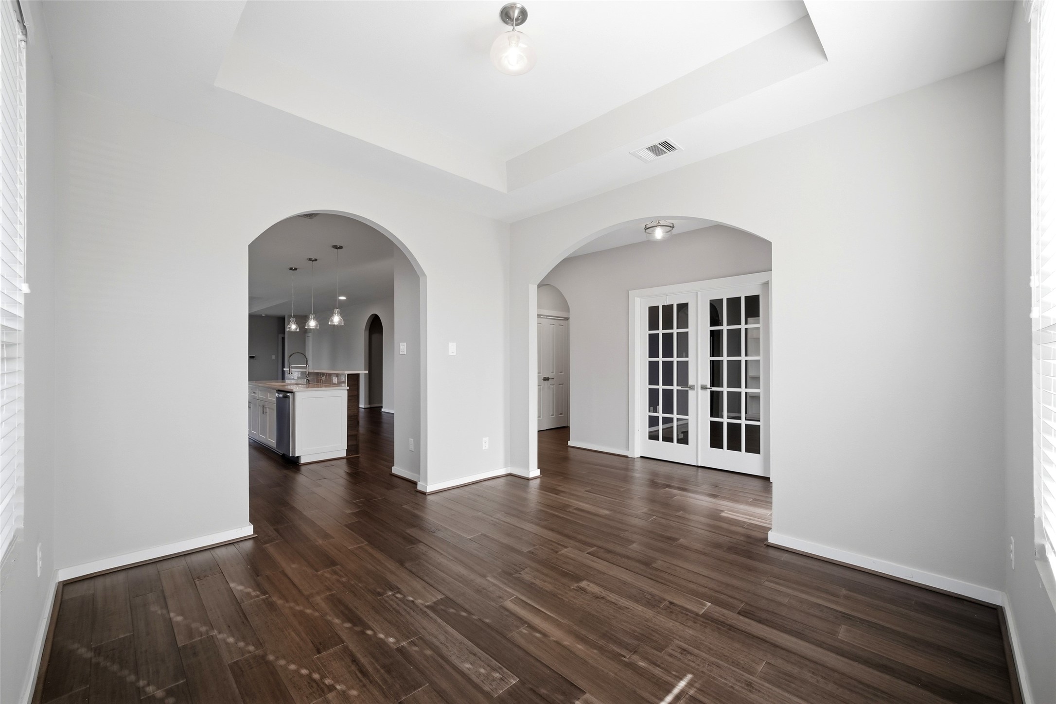 605 Dumble Street Houston, TX 77023 - Photo 11 of 44 a view of an empty room with wooden floor and a window