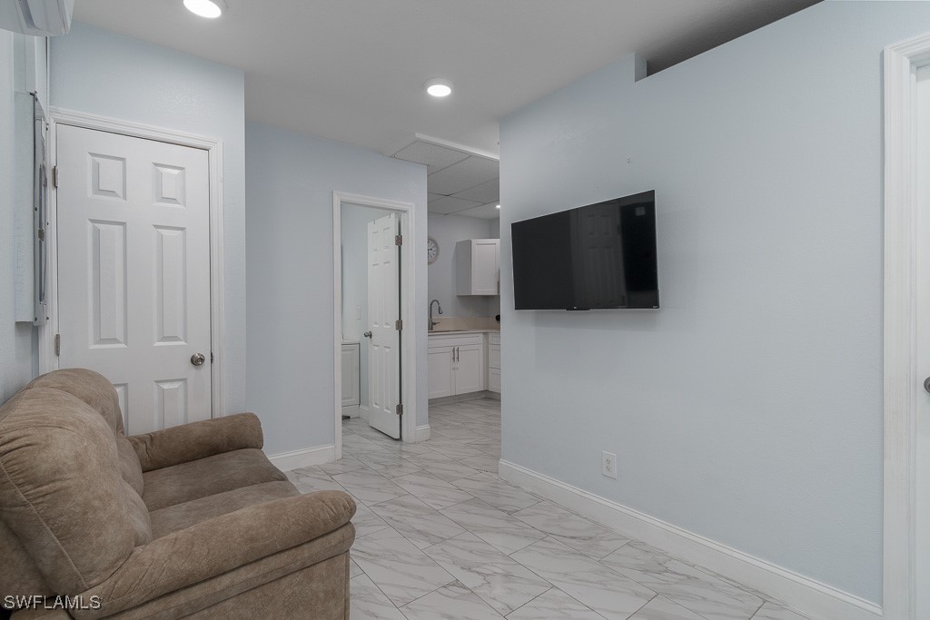 2808 9th Street Southwest Lehigh Acres, FL 33976 - Photo 19 of 34 a living room with furniture and a flat screen tv
