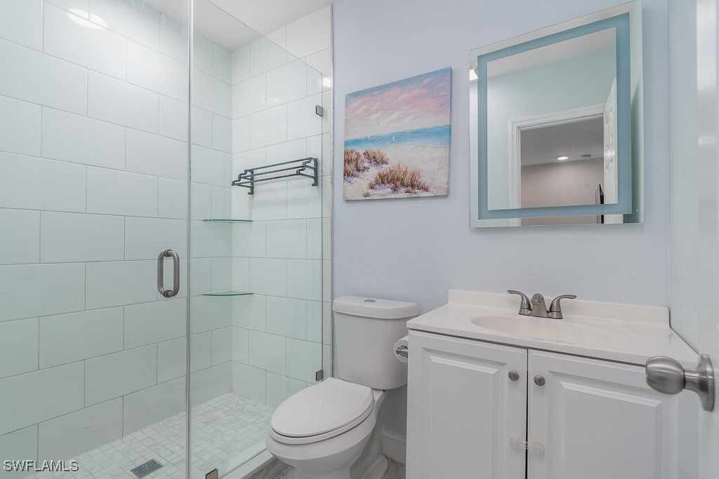 2808 9th Street Southwest Lehigh Acres, FL 33976 - Photo 21 of 34 a bathroom with a toilet sink vanity and shower