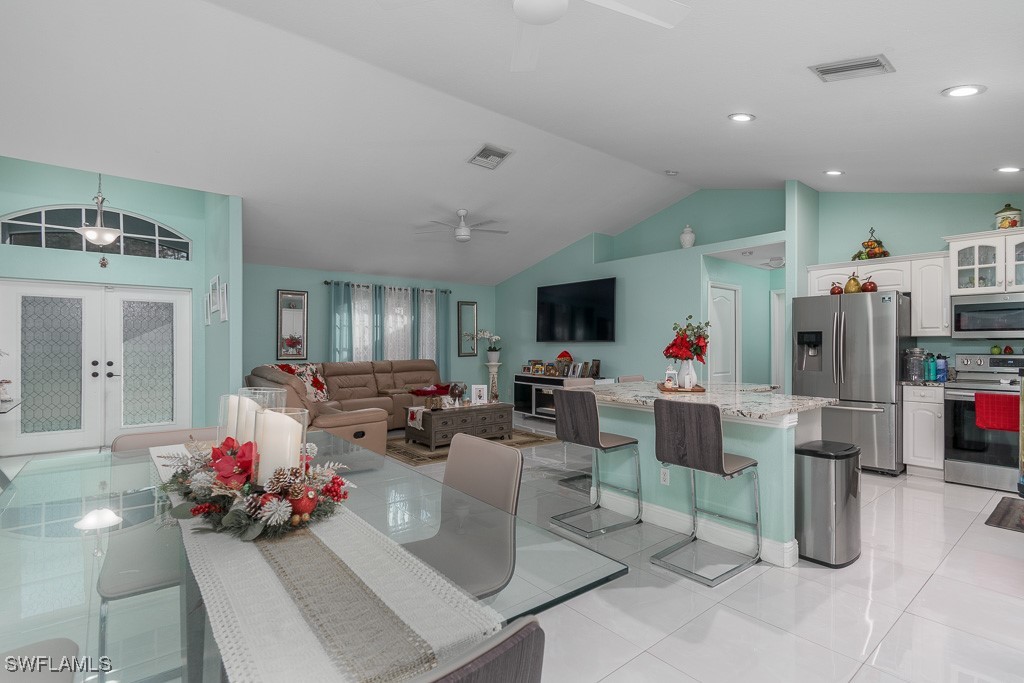 2808 9th Street Southwest Lehigh Acres, FL 33976 - Photo 22 of 34 a living room with furniture and a flat screen tv