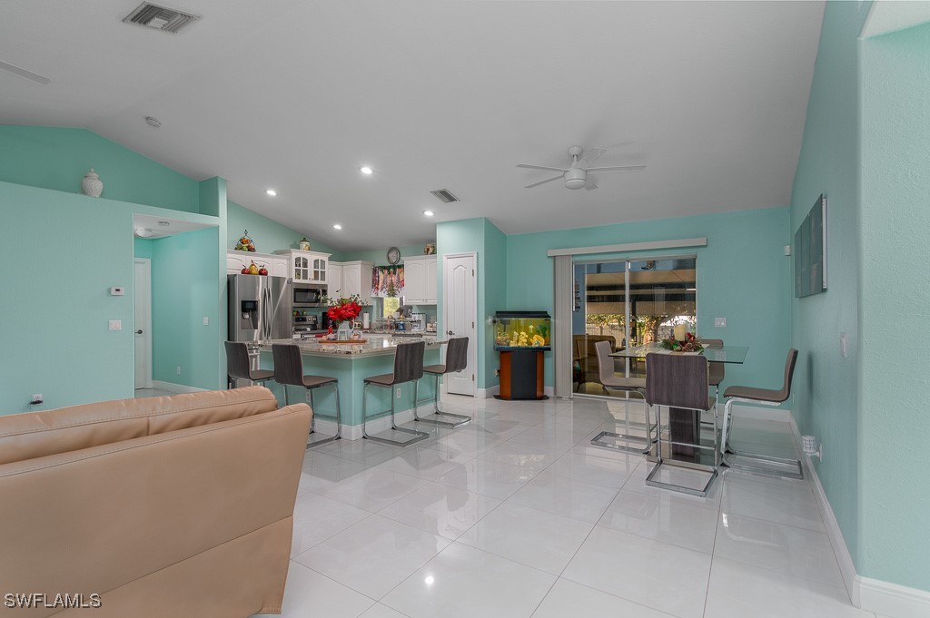 2808 9th Street Southwest Lehigh Acres, FL 33976 - Photo 23 of 34 a living room with furniture and a view of kitchen