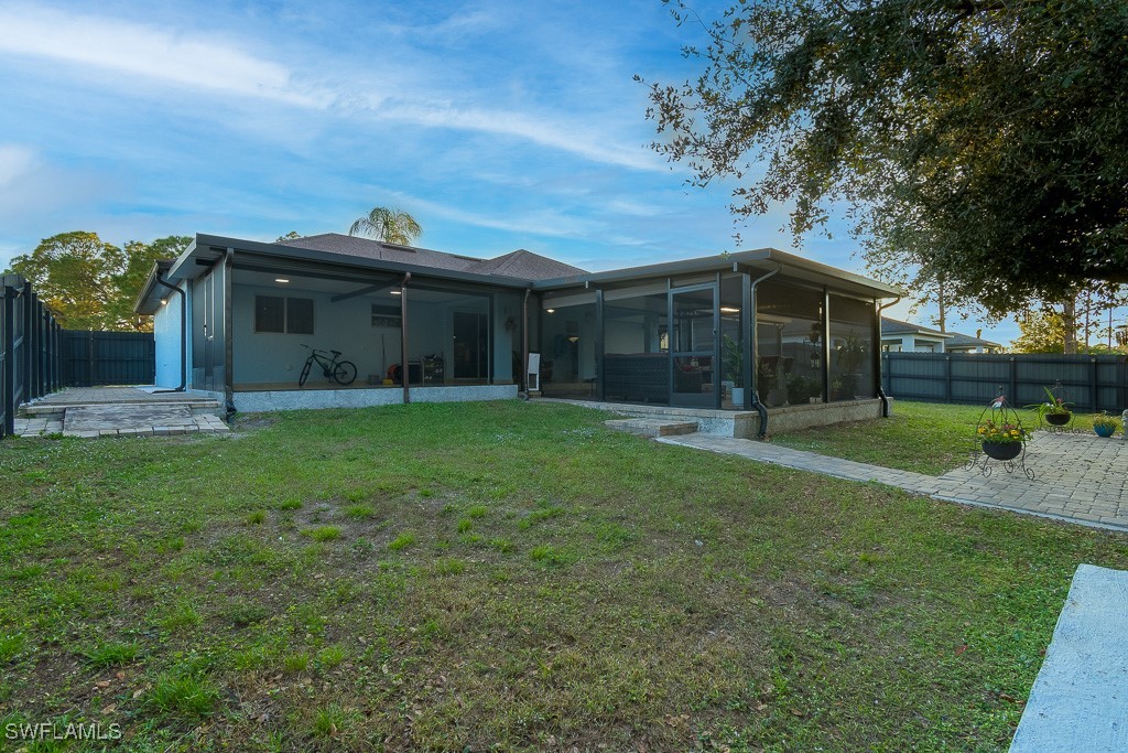 2808 9th Street Southwest Lehigh Acres, FL 33976 - Photo 28 of 34 a view of a house with backyard and porch