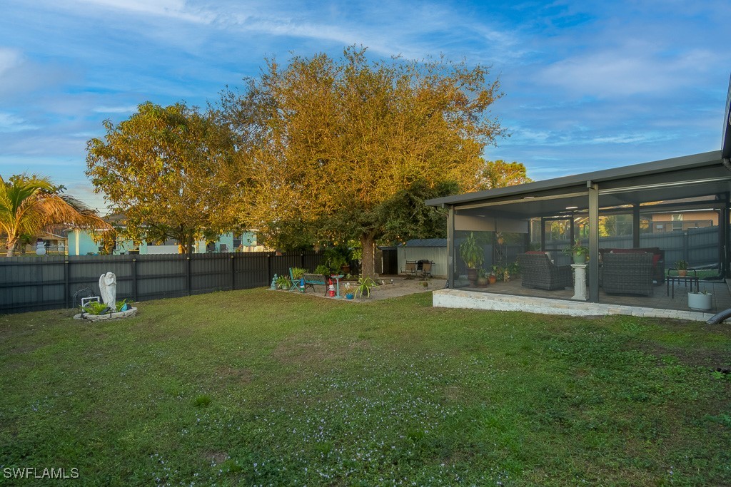 2808 9th Street Southwest Lehigh Acres, FL 33976 - Photo 30 of 34 a backyard of a house with lots of green space