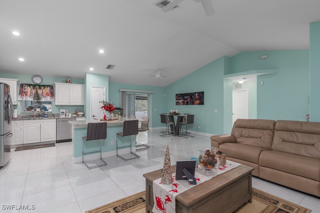 2808 9th Street Southwest Lehigh Acres, FL 33976 - Photo 3 of 34 a living room with furniture and kitchen view