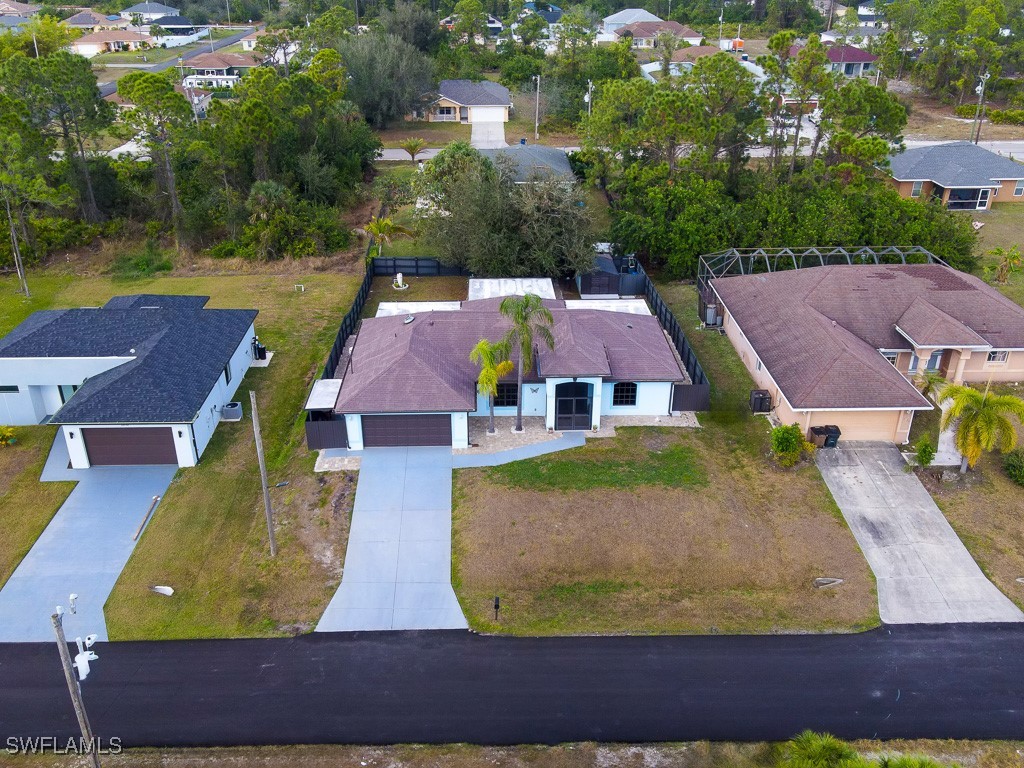 2808 9th Street Southwest Lehigh Acres, FL 33976 - Photo 33 of 34 an aerial view of residential houses with outdoor space and a lake view