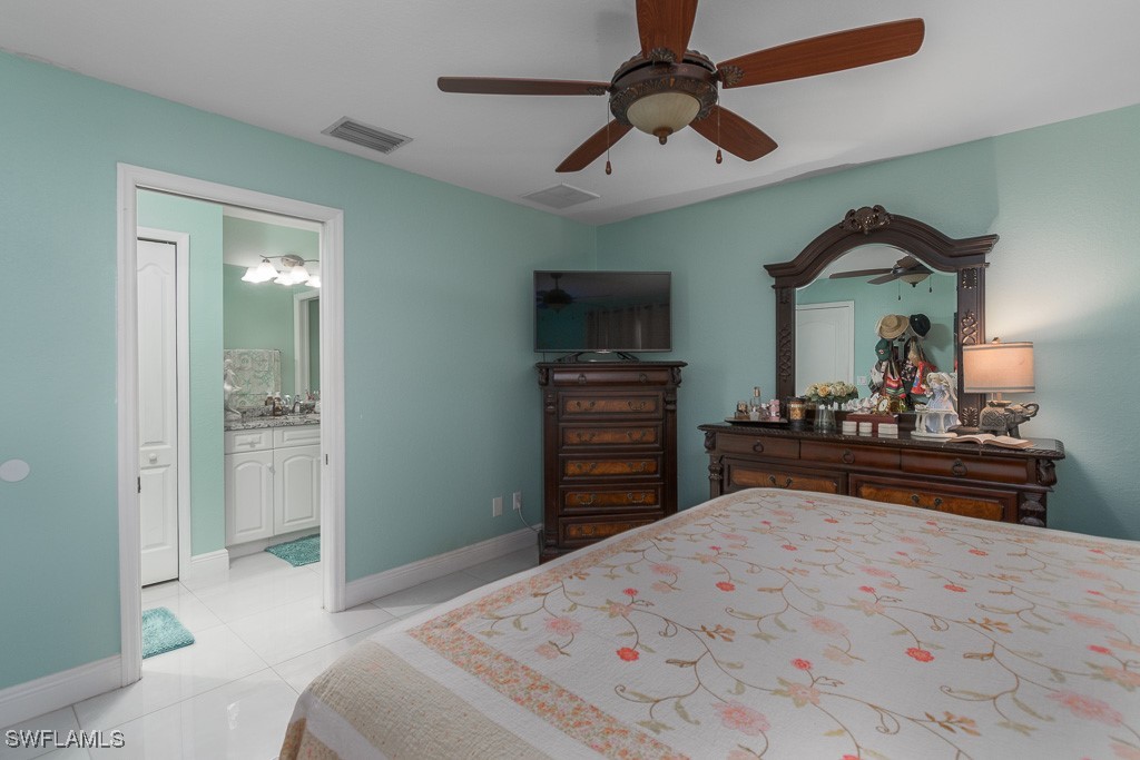 2808 9th Street Southwest Lehigh Acres, FL 33976 - Photo 7 of 34 a bedroom with a bed and a flat screen tv