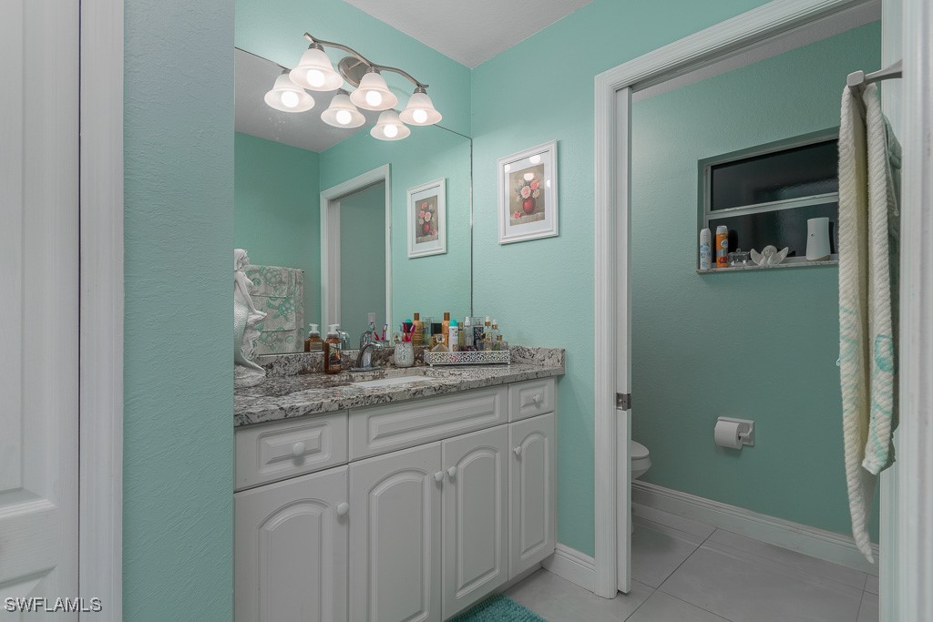 2808 9th Street Southwest Lehigh Acres, FL 33976 - Photo 8 of 34 a bathroom with a double vanity sink and a mirror