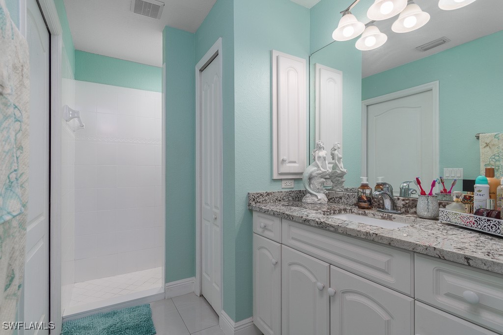 2808 9th Street Southwest Lehigh Acres, FL 33976 - Photo 9 of 34 a bathroom with a granite countertop sink and a mirror