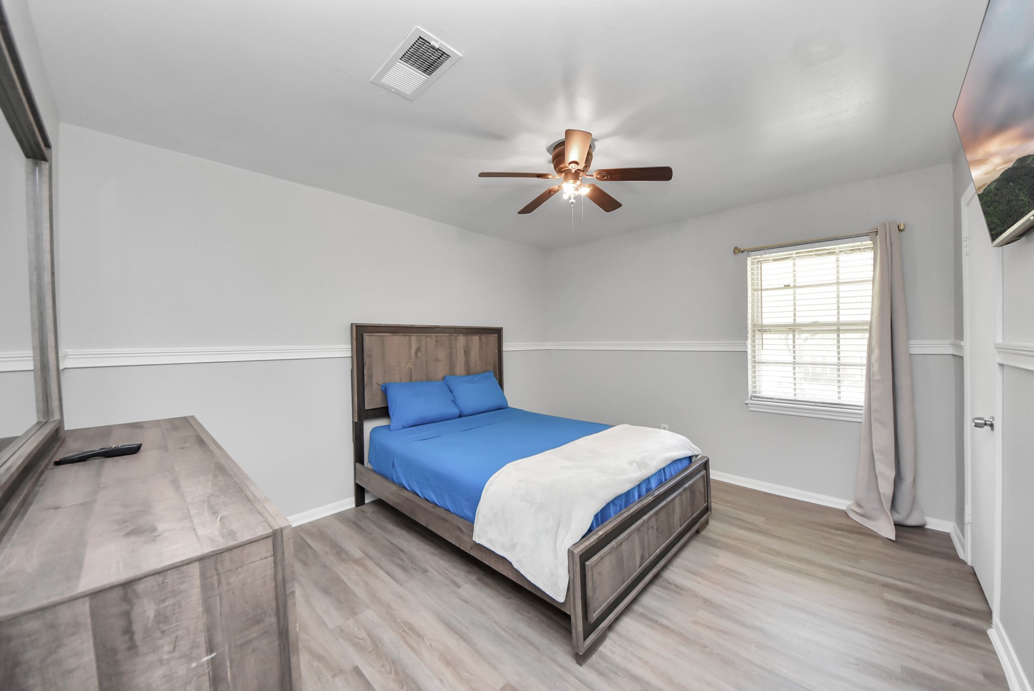 1011 Whitestone Lane Houston, TX 77073 - Photo 15 of 48 a bedroom with a bed and a chandelier