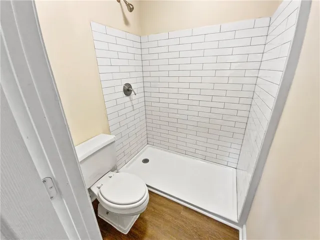 a bathroom with a toilet and a shower