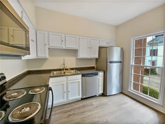 a kitchen with a stove and a refrigerator