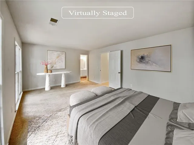 a bed room with a bed and a painting