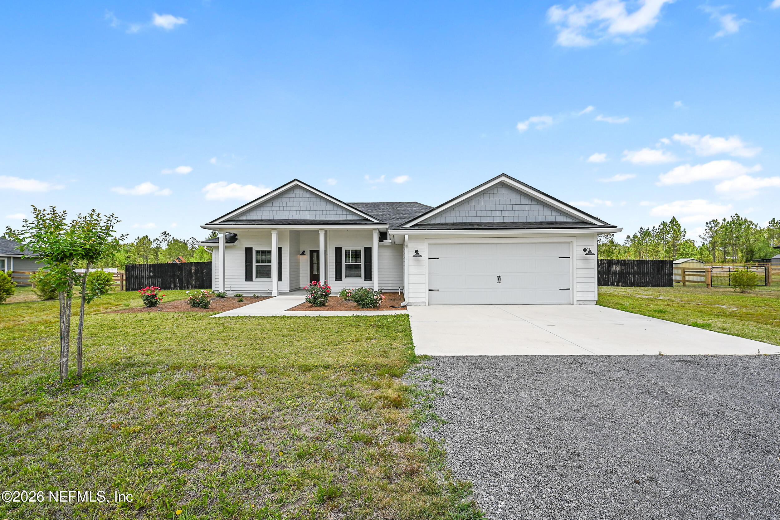 8685 Odis Yarborough Road Glen St. Mary, FL 32040 - Photo 2 of 59 a front view of house with a garden and patio