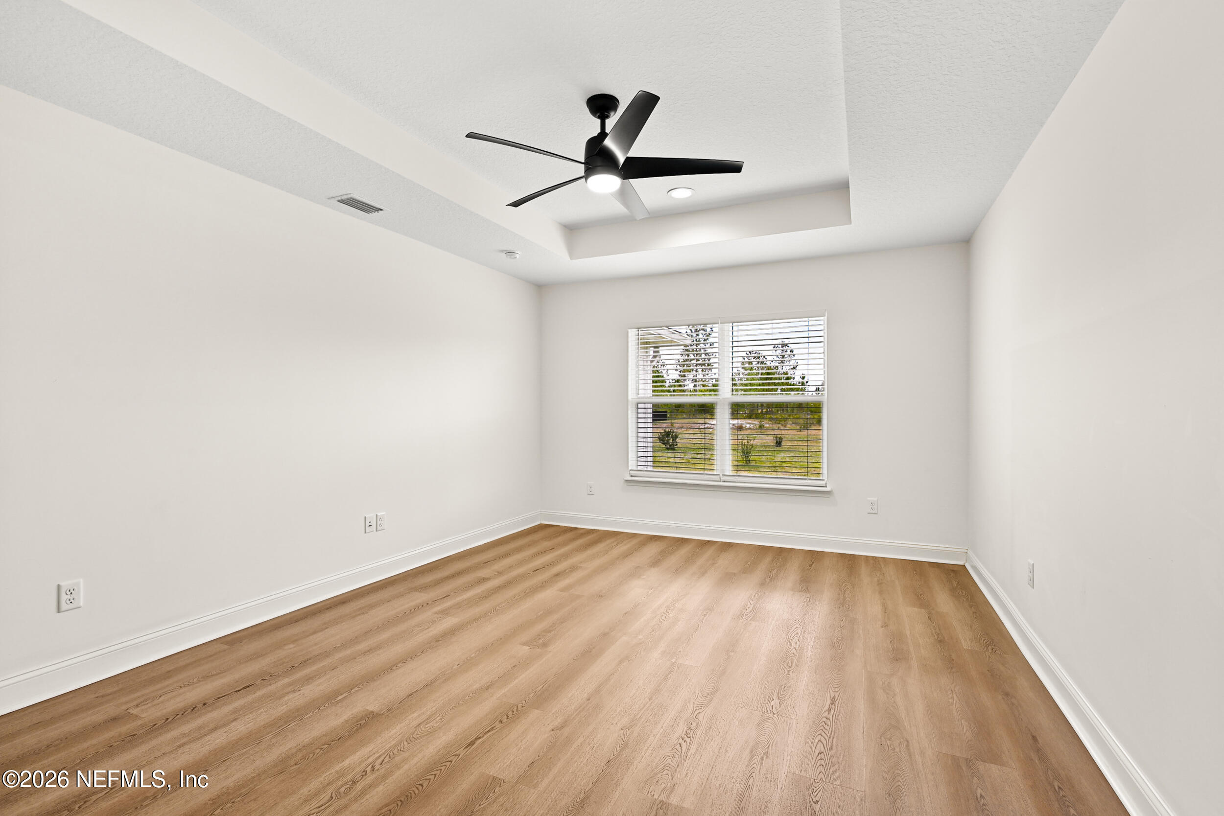 8685 Odis Yarborough Road Glen St. Mary, FL 32040 - Photo 23 of 59 a view of empty room with wooden floor and fan