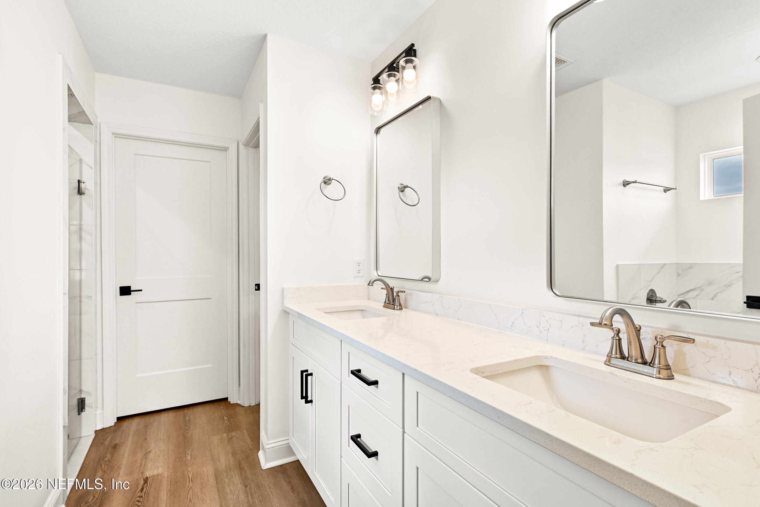 8685 Odis Yarborough Road Glen St. Mary, FL 32040 - Photo 25 of 59 a bathroom with a double vanity sink mirror and