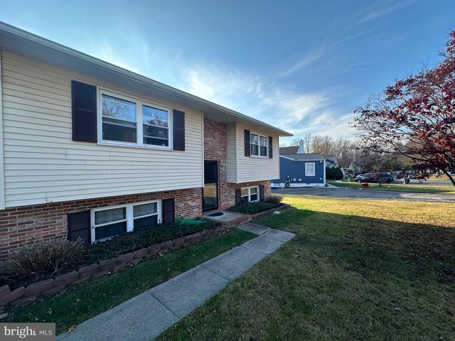 a view of house with swimming pool and yard