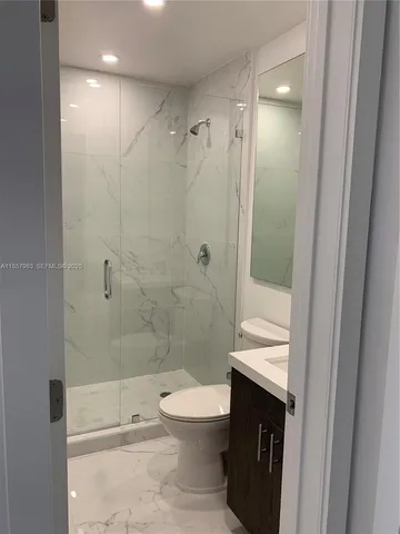 a bathroom with a toilet a sink and shower