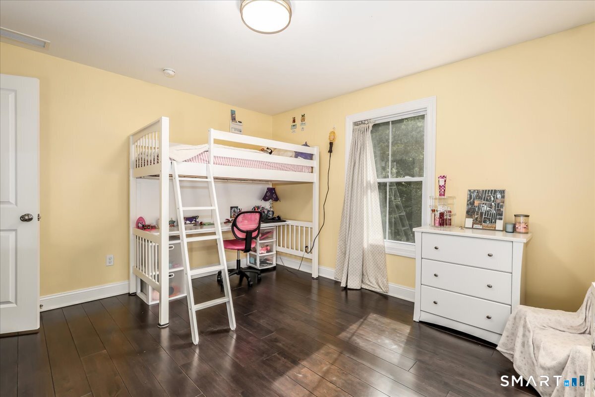 127 Putnam Park Road Bethel, CT 06801 - Photo 20 of 35 a view of a room with wooden floor cabinet and windows