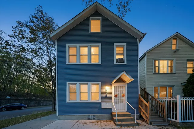 a front view of a house with parking area
