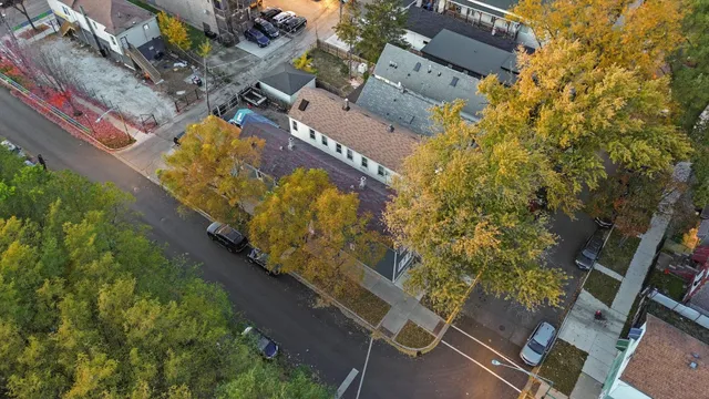 an aerial view of a house with outdoor space and sitting area