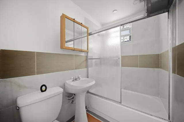 a bathroom with a sink toilet and shower
