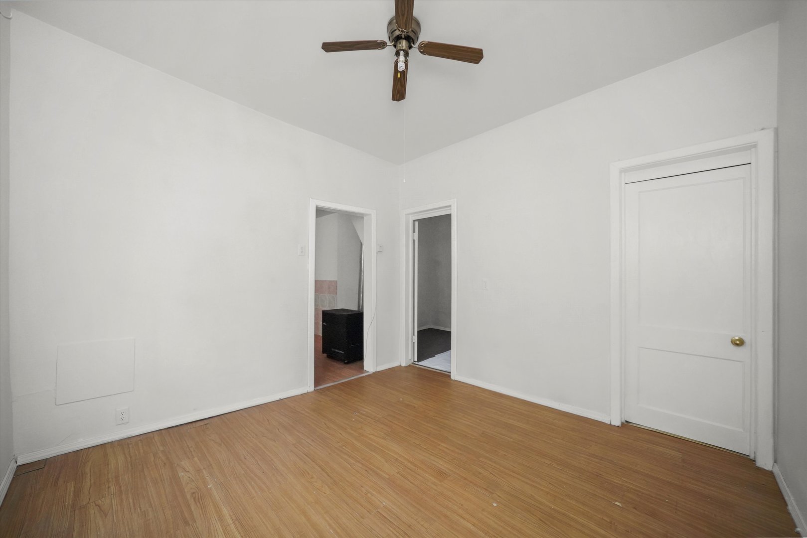 4858 South Justine Street Chicago, IL 60609 - Photo 7 of 20 a view of a room with a ceiling fan and wooden floor