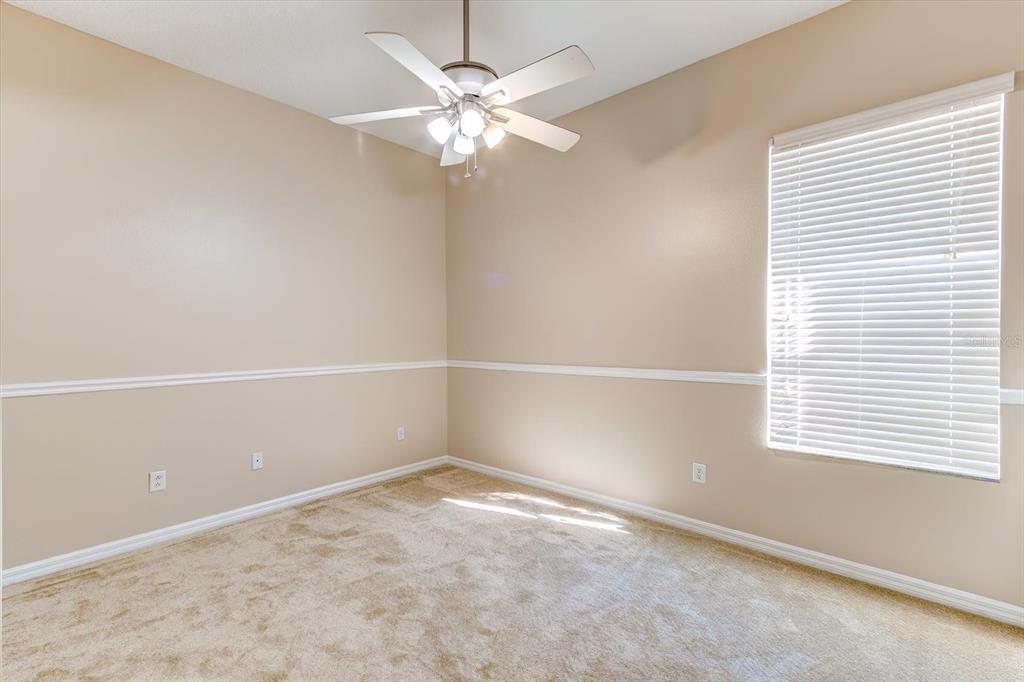 276 Longhirst Loop Ocoee, FL 34761 - Photo 30 of 60 an empty room with a window and chandelier fan