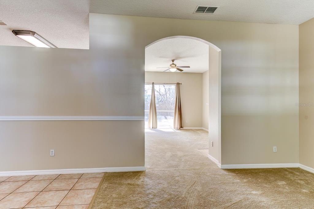276 Longhirst Loop Ocoee, FL 34761 - Photo 9 of 60 an empty room with wooden floor and windows