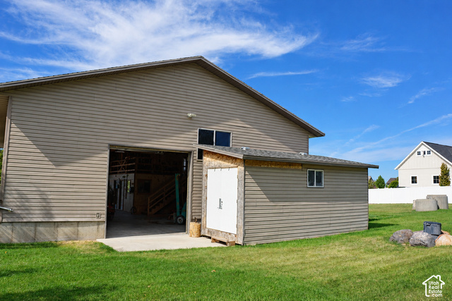 580 North 300 East Logan, UT 84321 - Photo 60 of 96 Two-story auxiliary building with horizontal siding and a large bay door