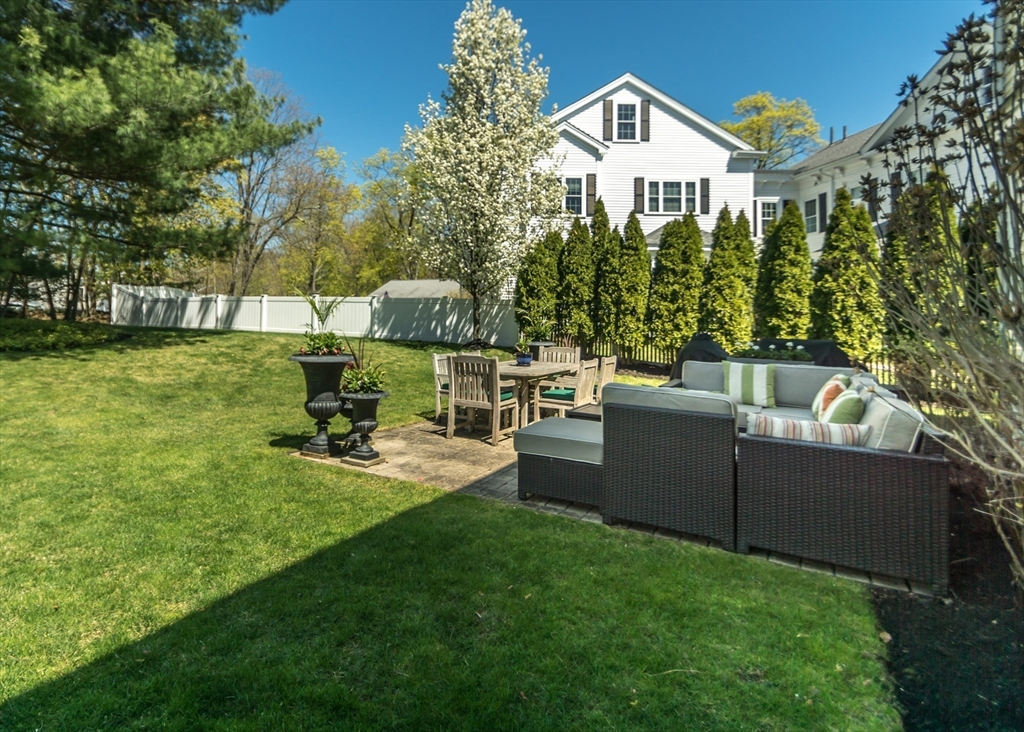 128 Church Street, Unit 2 Waltham, MA 02452 - Photo 39 of 41 a view of a house with a yard and sitting area