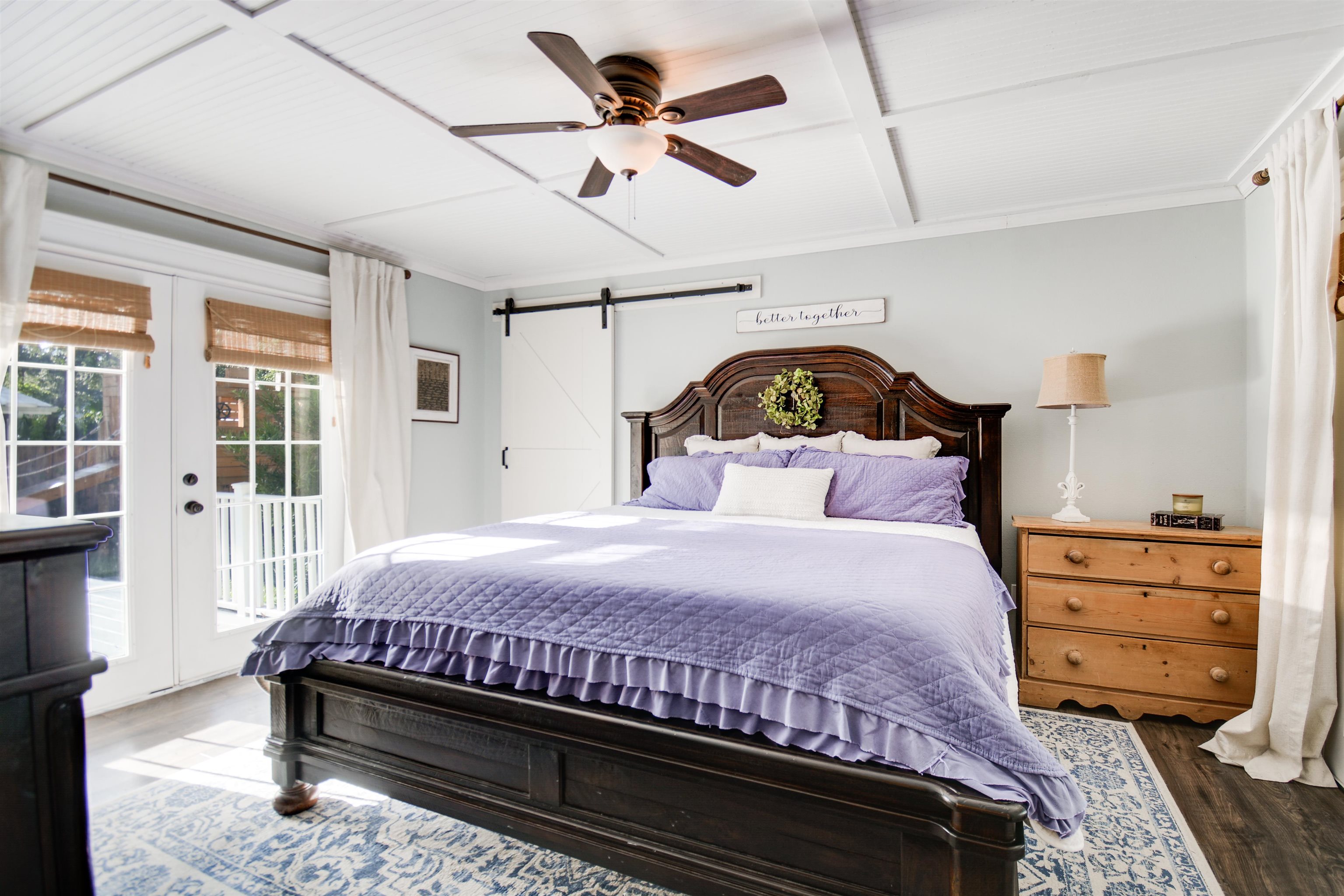 156 Egret Road St. Augustine, FL 32086 - Photo 20 of 44 a bedroom with a large bed and a chandelier