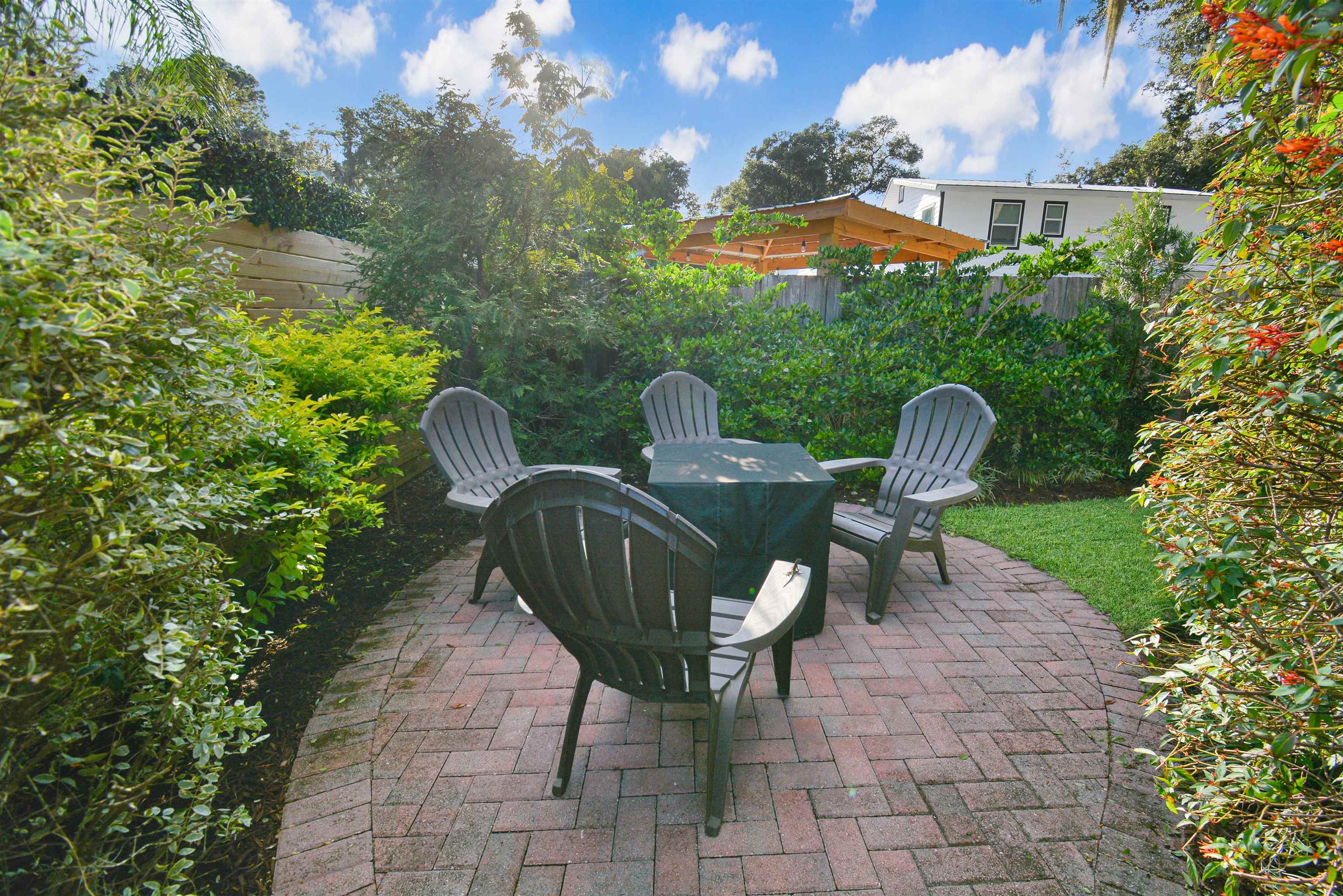 156 Egret Road St. Augustine, FL 32086 - Photo 23 of 44 a view of a chair and table in the backyard under an umbrella