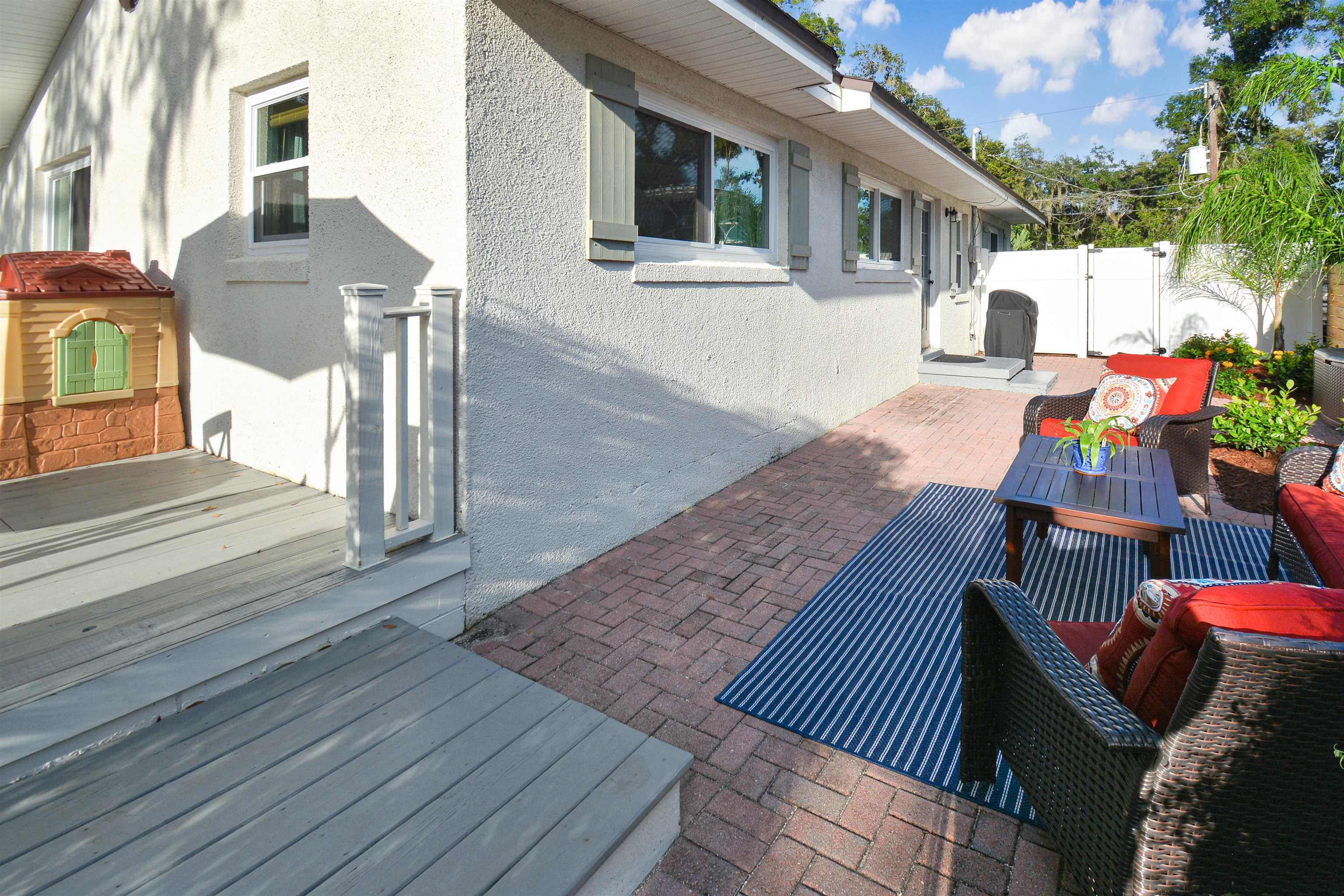 156 Egret Road St. Augustine, FL 32086 - Photo 33 of 44 a view of a patio with couches and table and chairs with wooden floor
