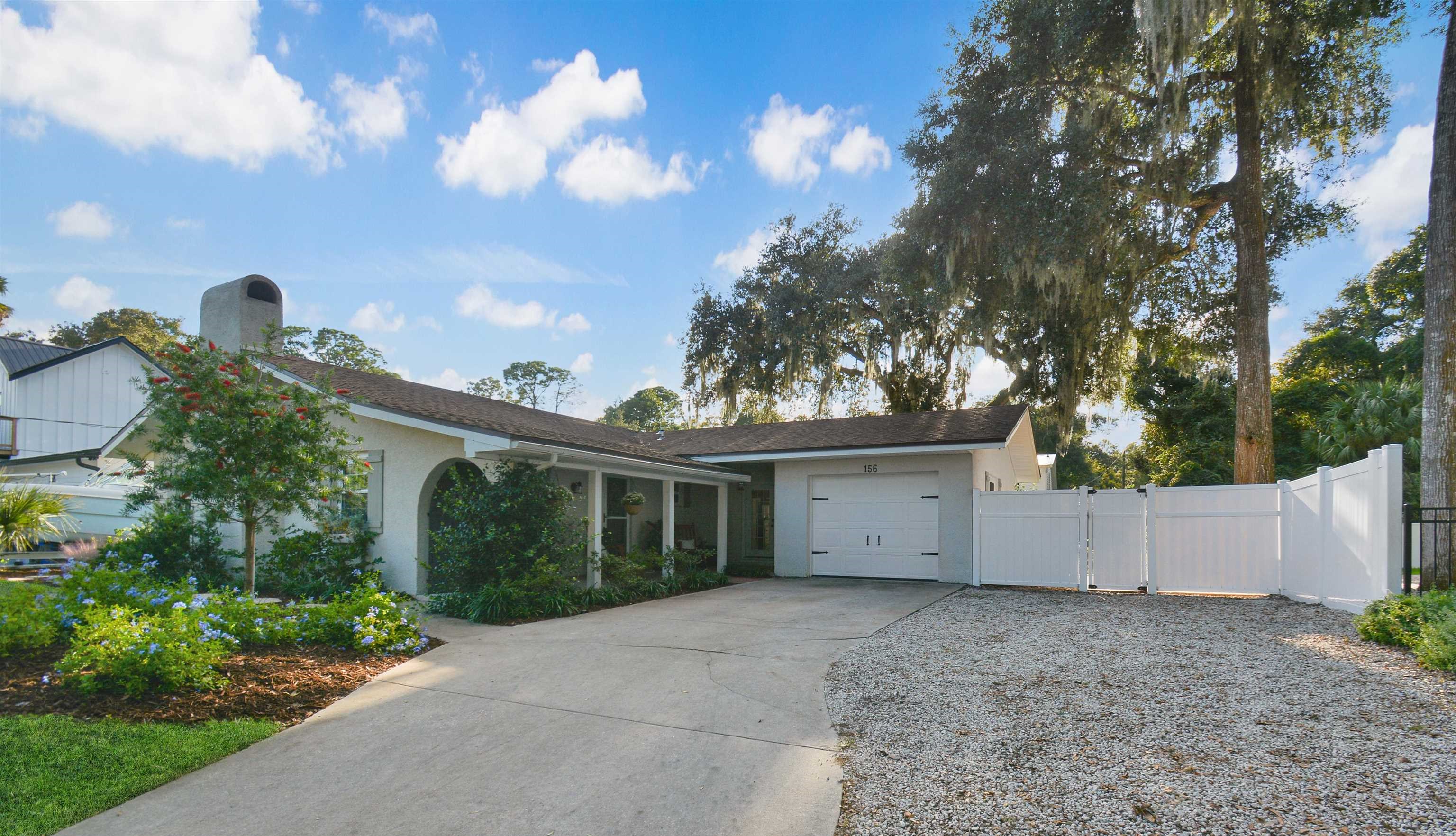 156 Egret Road St. Augustine, FL 32086 - Photo 37 of 44 a view of house with a yard and potted plants