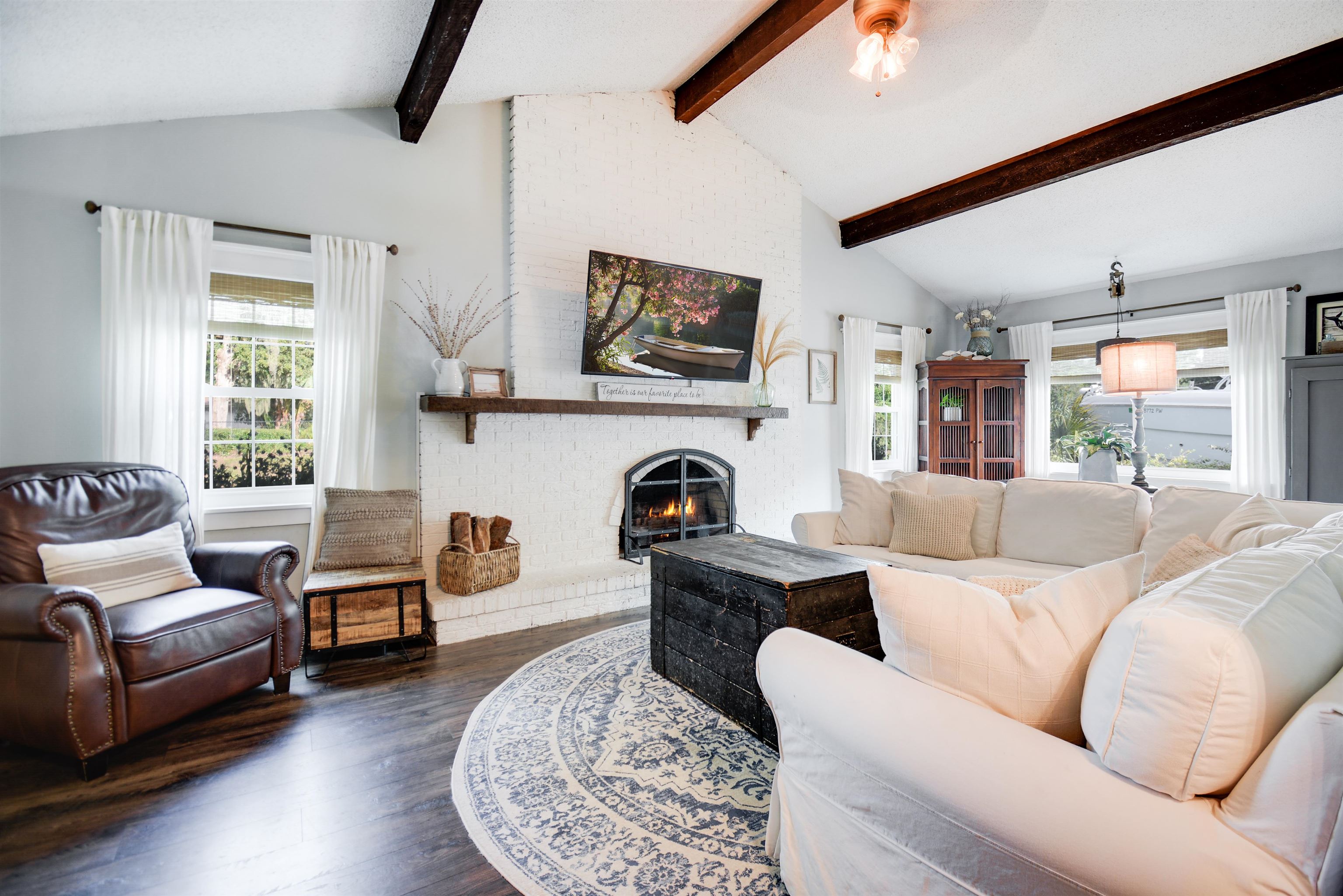 156 Egret Road St. Augustine, FL 32086 - Photo 4 of 44 a living room with furniture a fireplace and a large window
