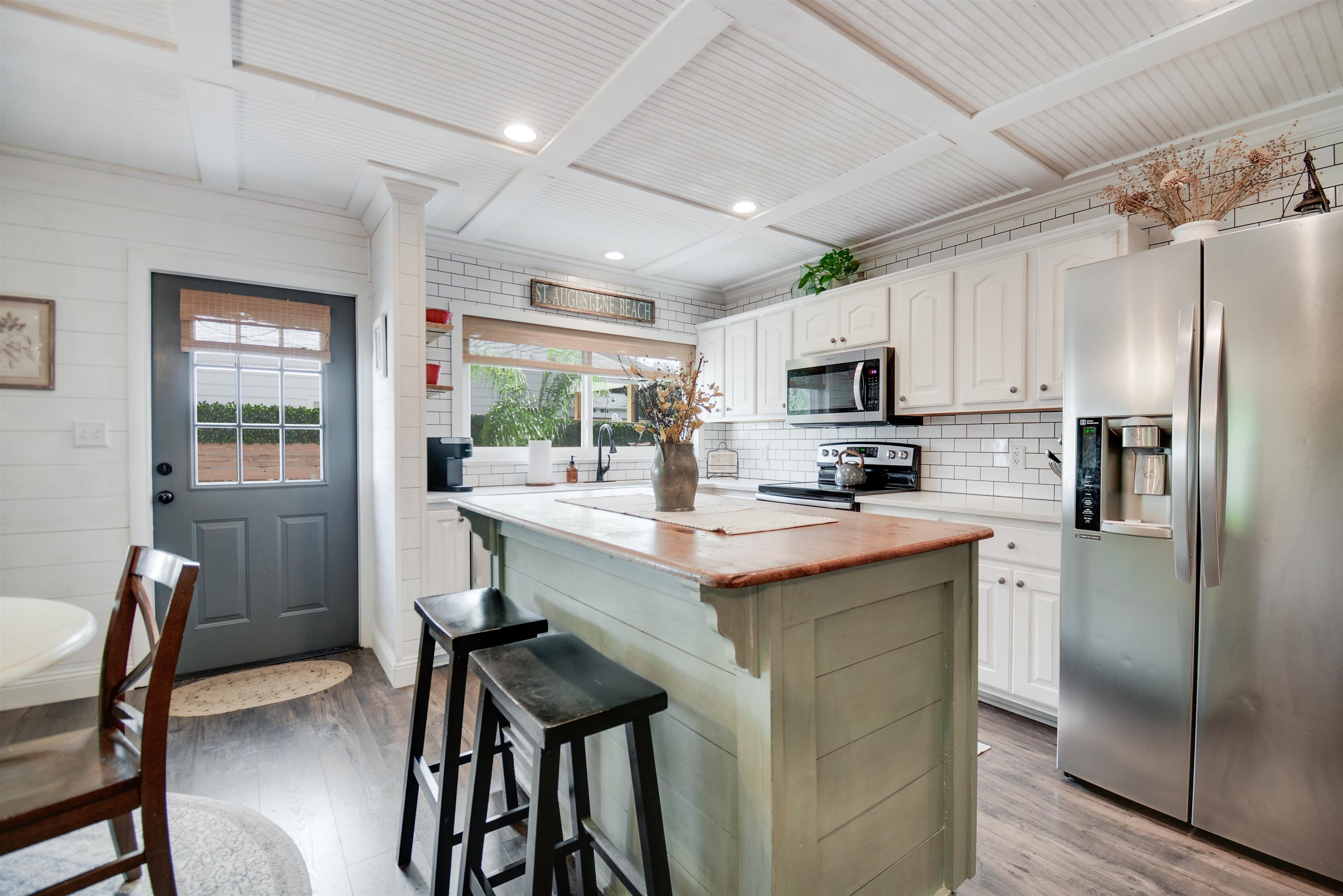 156 Egret Road St. Augustine, FL 32086 - Photo 10 of 44 a kitchen with kitchen island a refrigerator stove and microwave