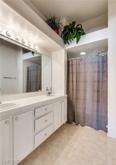 5272 Island Chain Road Las Vegas, NV 89118 - Photo 8 of 31 Double vanity and tiled flooring adorn this practical and well-appointed bathroom.