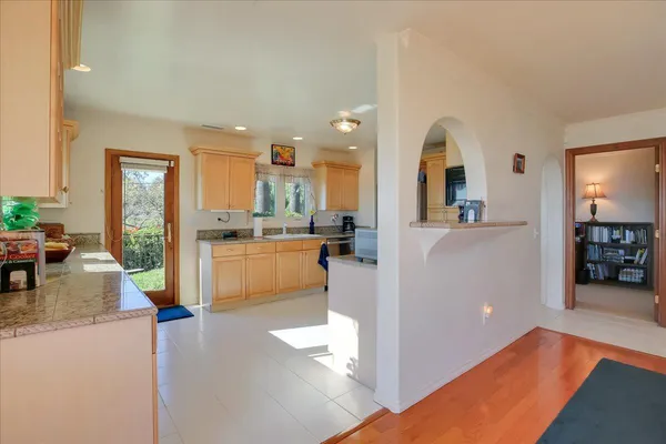 a kitchen with stainless steel appliances granite countertop a refrigerator and a sink