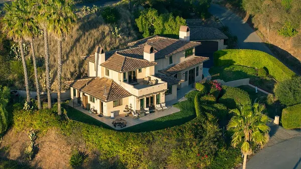 a aerial view of a house with swimming pool and garden
