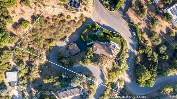 an aerial view of a house with a swimming pool
