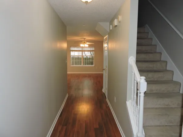 a view of entryway and hall with wooden floor