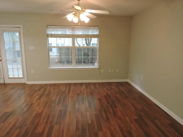 wooden floor in an empty room with a window