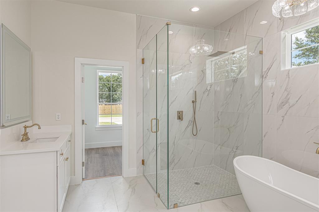 360 Dalton Road Canton, TX 75103 - Photo 17 of 33 Spacious bathroom featuring a frameless glass shower enclosure, a freestanding soaking tub, and a white vanity with a rectangular sink