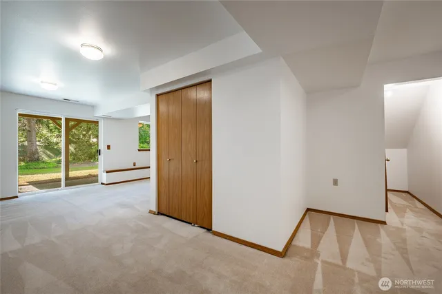 an empty room with windows and closet