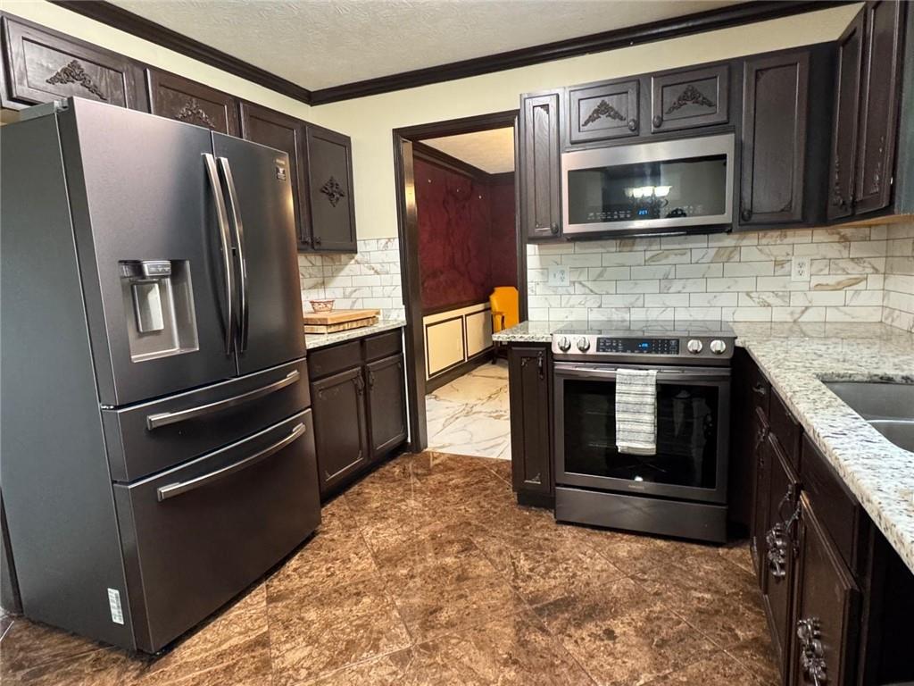 29 Lighthouse Drive Winder, GA 30680 - Photo 11 of 33 a kitchen with granite countertop a refrigerator and a stove top oven