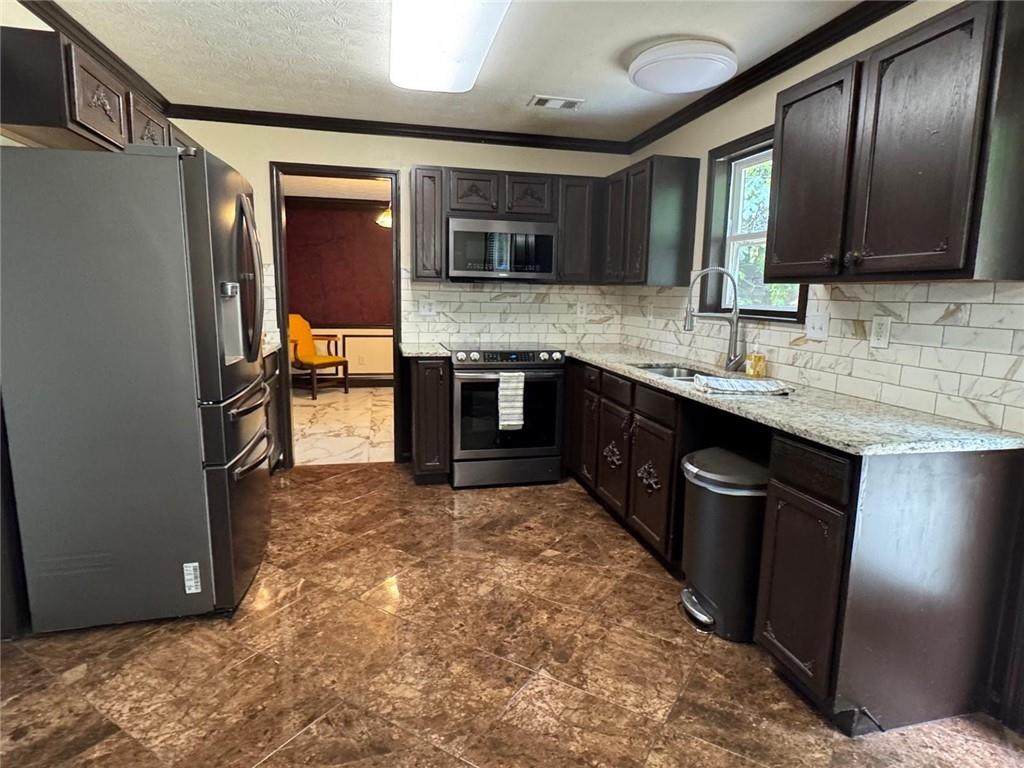 29 Lighthouse Drive Winder, GA 30680 - Photo 12 of 33 a kitchen with stainless steel appliances granite countertop a sink stove and refrigerator