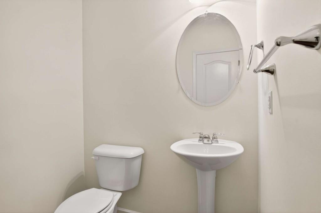 7631 Bucknell Terrace Fairburn, GA 30213 - Photo 16 of 43 a bathroom with a toilet sink and mirror