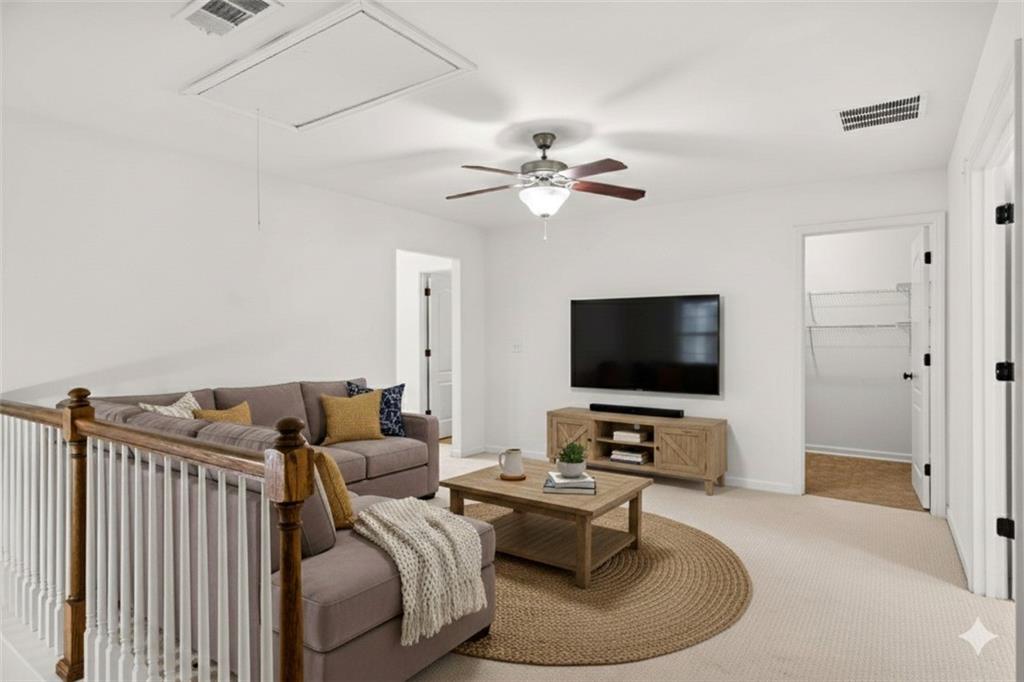 7631 Bucknell Terrace Fairburn, GA 30213 - Photo 17 of 43 a living room with furniture and a flat screen tv